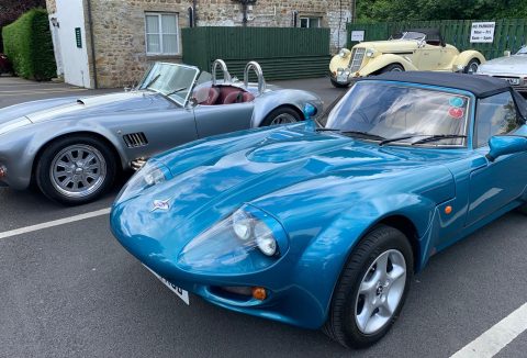 Close-up view of a blue TVR Griffith convertible with a smooth design.