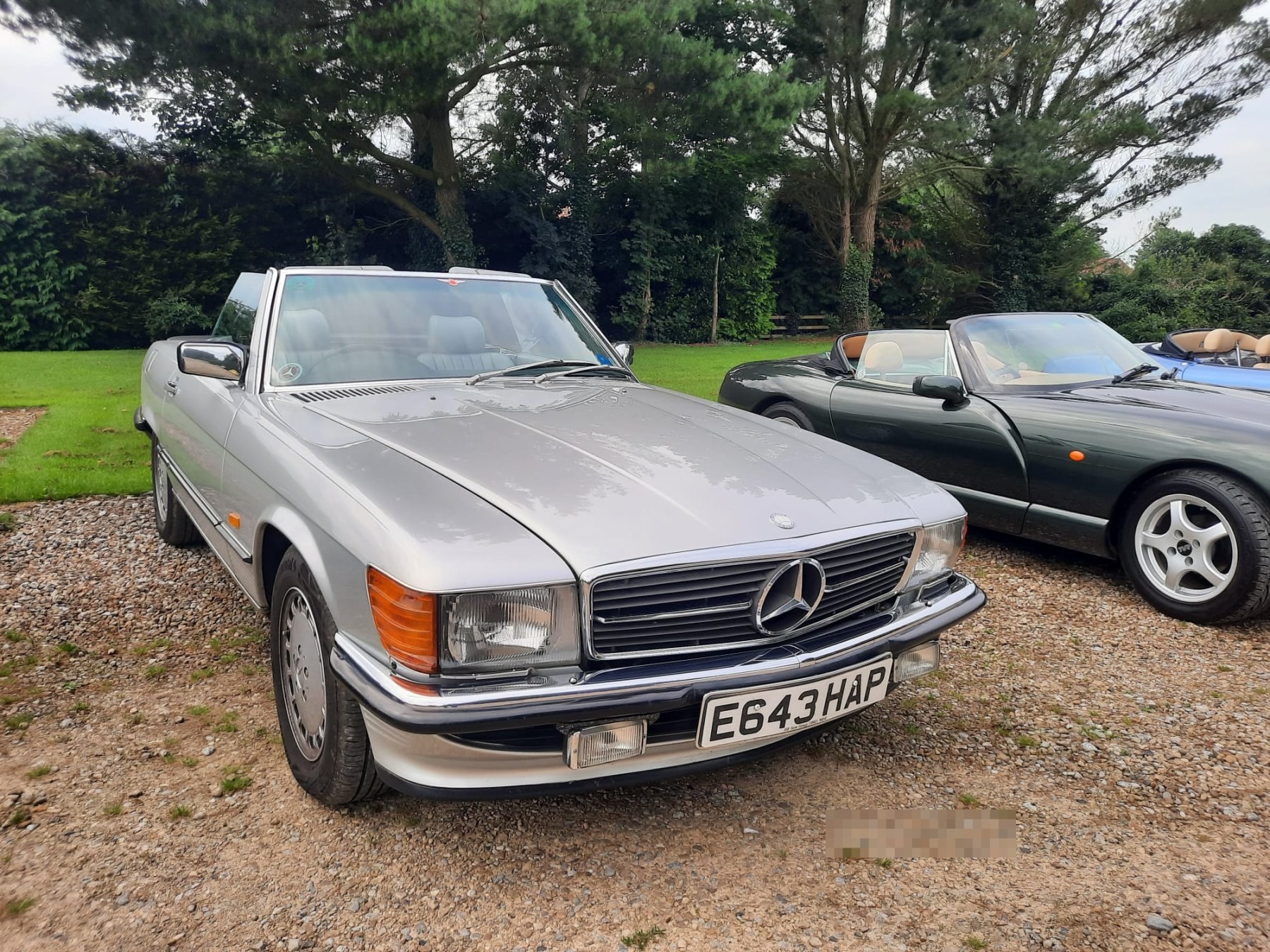 Mercedes-Benz SL-Class convertible parked in a garden.