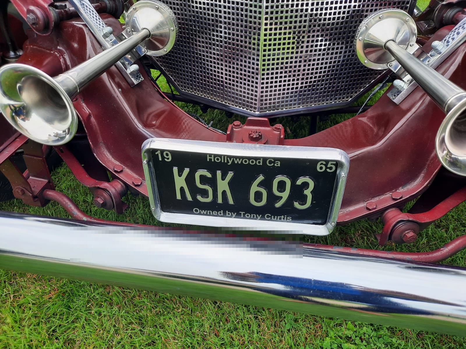Close-up of Ford Model T showing grille and horns.